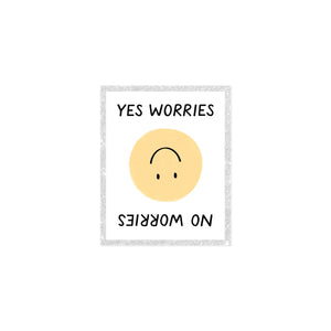 Image of decorative sticker with white background and glittery border with yellow smiley face in center and black text says, "Yes Worries" and "No worries" on top and bottom of sticker. 