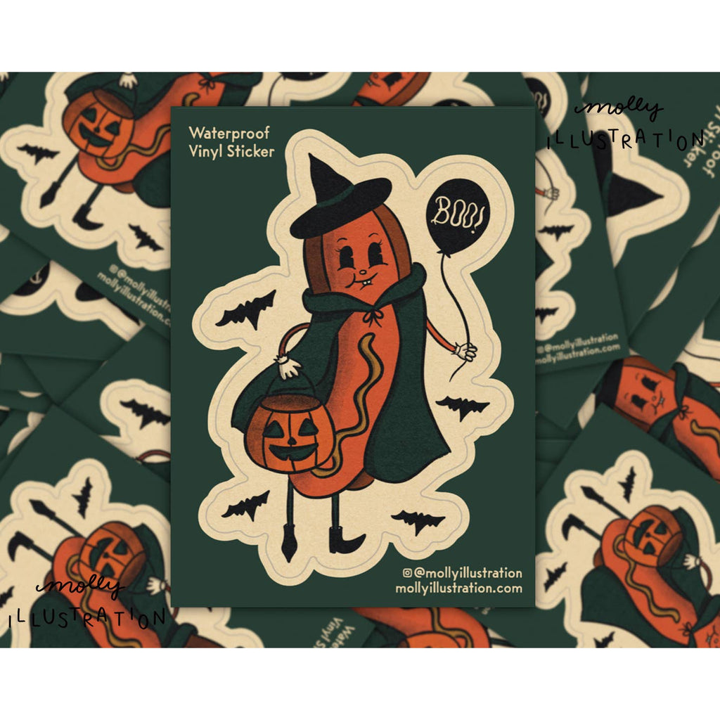 Decorative sticker with cream background and image of a hot dog dresseing up as a witch holding a black balloon with white text says, "boo!". 