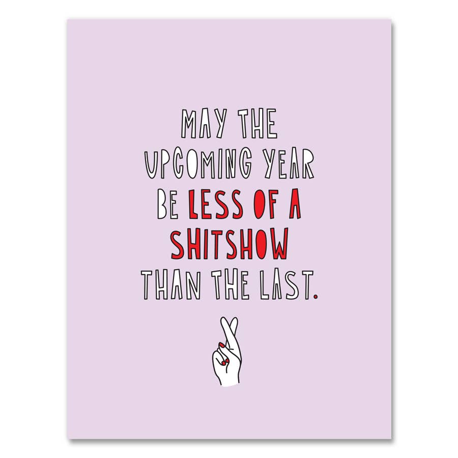 Greeting card with pink background and image of a hand with two fingers crossed. Red and white text says, "May the upcoming year be less of a shitshow than the last.". Envelope included. 