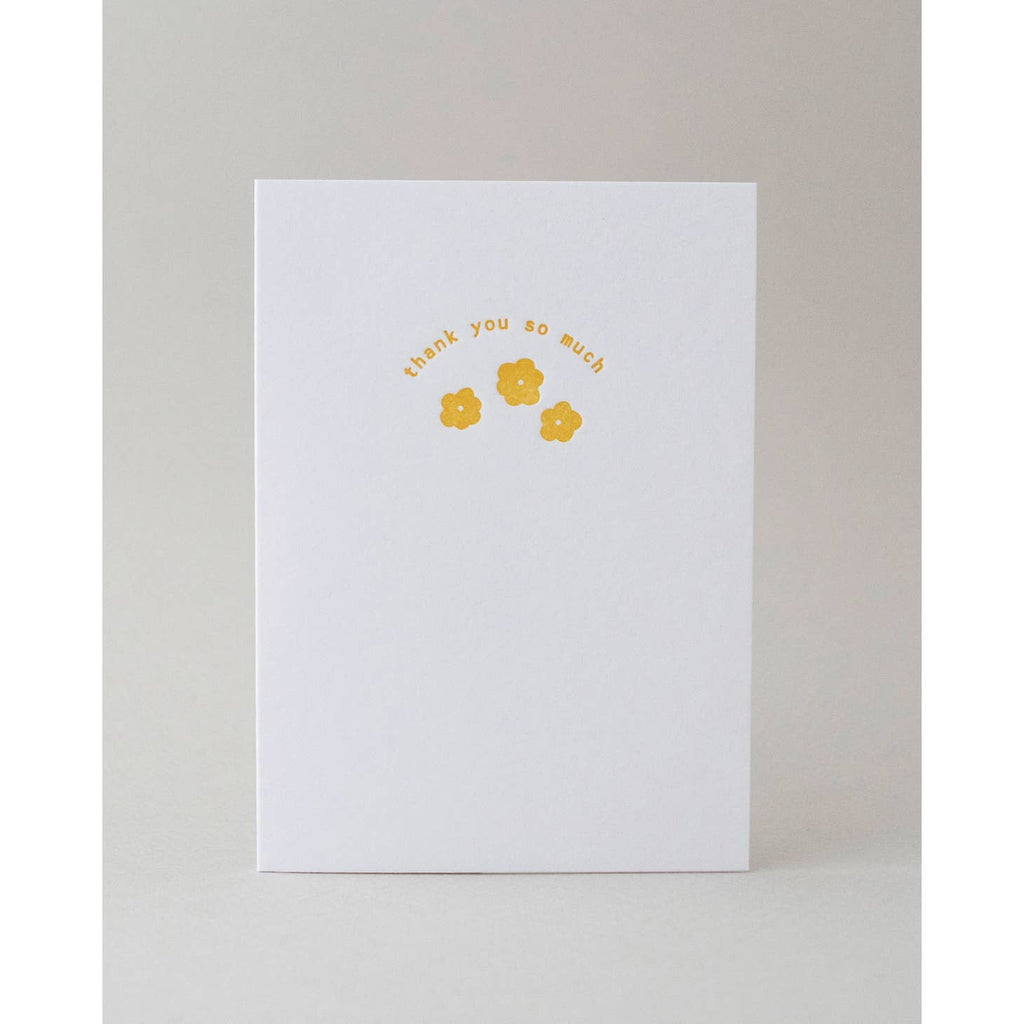 White background with image of three yellow flowers and yellow text says, "Thank you so much". Envelope is included. 
