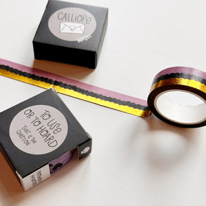 Image of Washi tape with horizontal scalloped pattern in pink, black and gold foil.