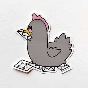 Image of sticker of a grey chicken with pink crest and holding a white envelope in its yellow beak and sitting on a nest of envelopes with one saying"Bock Bock" in black text.  