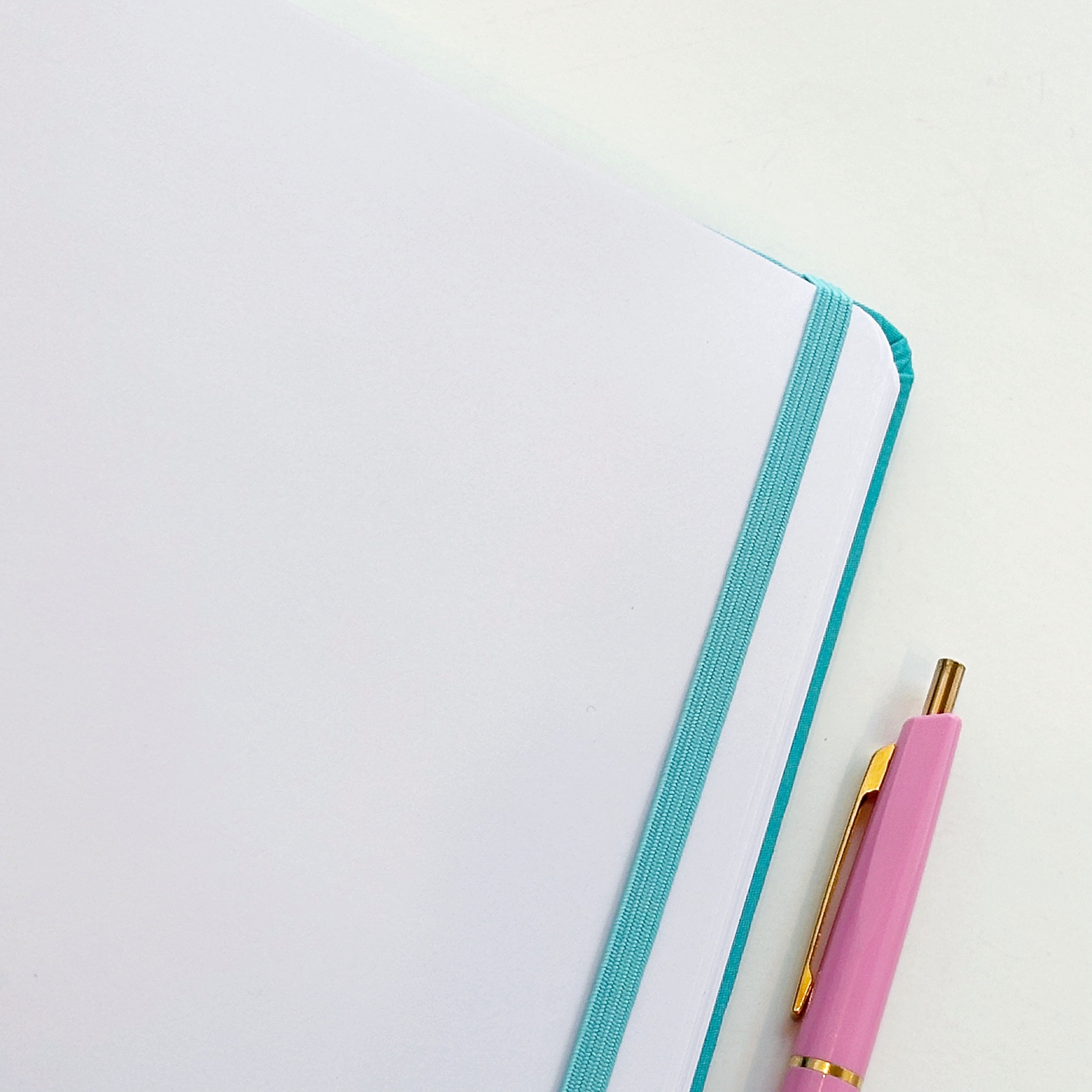 Image of white  and light blue dot grid page of journal. 