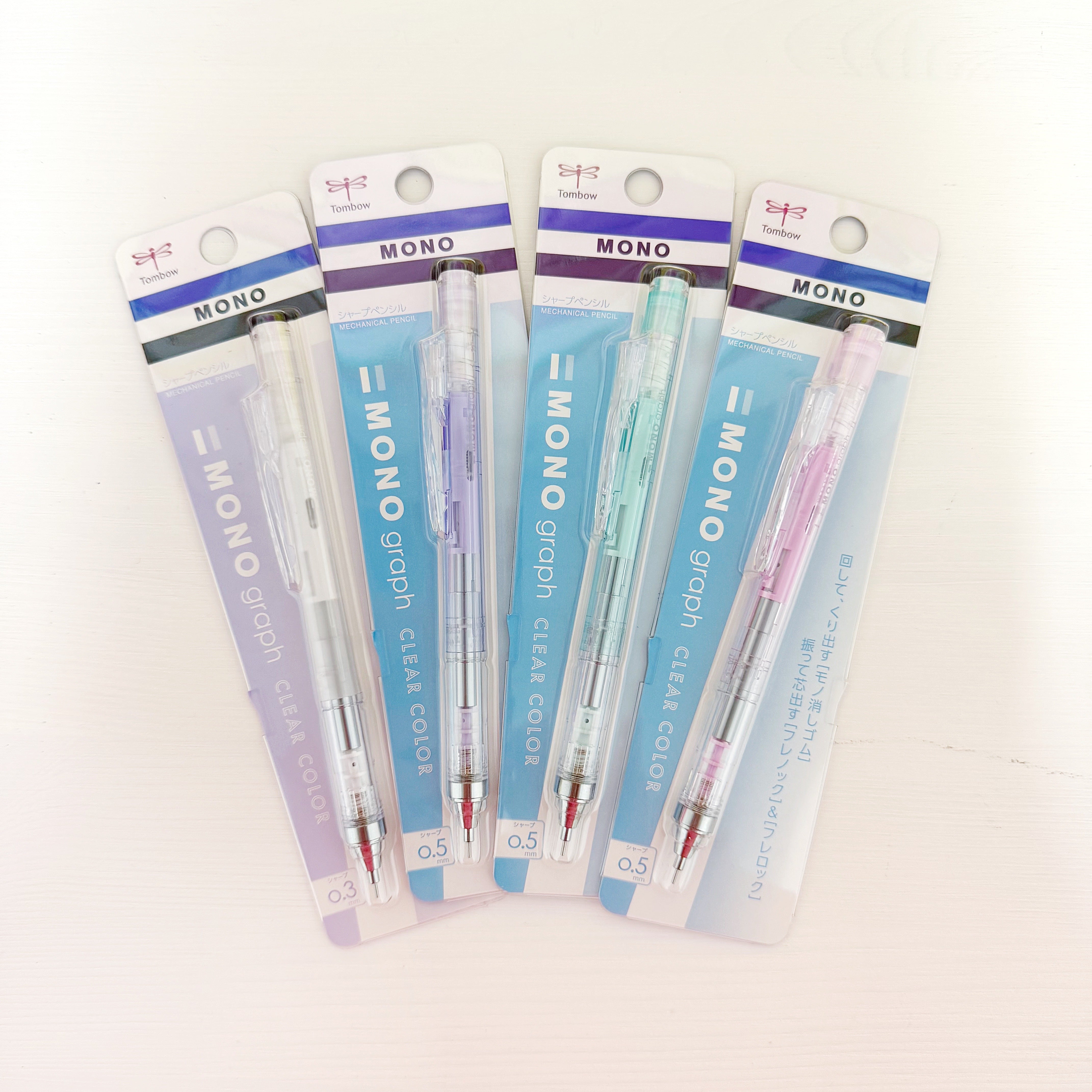 Mechanical pencils in clear, lilac, mint green and pink barrels.