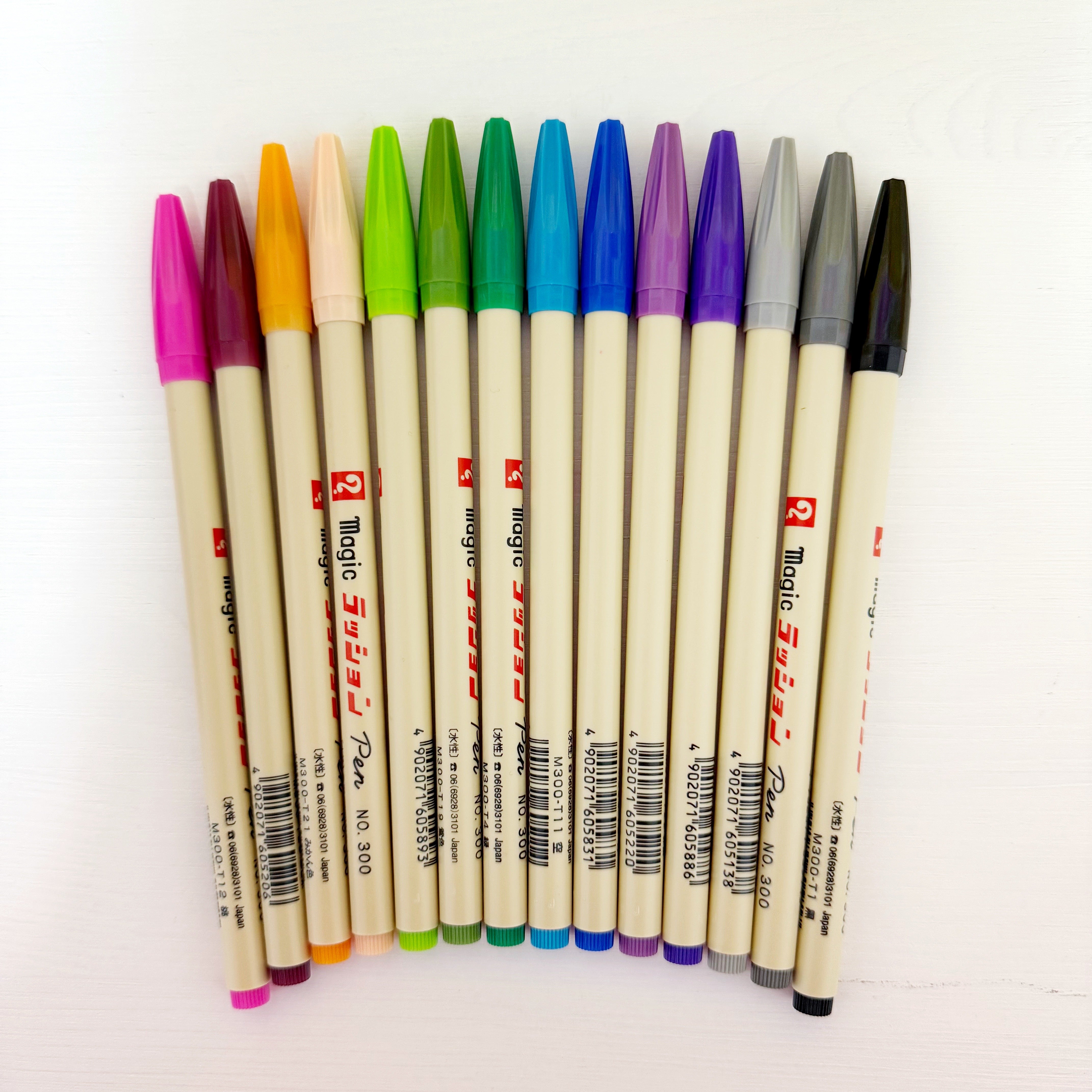 Image of pens in rainbow of colors with cream barrels and caps in colors.