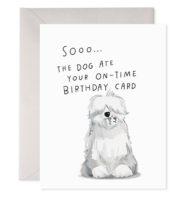 Greeting card with white background with image of grey and white sheepdog with a birthday card in its mouth. Black text says, "Sooo...the dog ate your on-time birthday card". Grey envelope included.