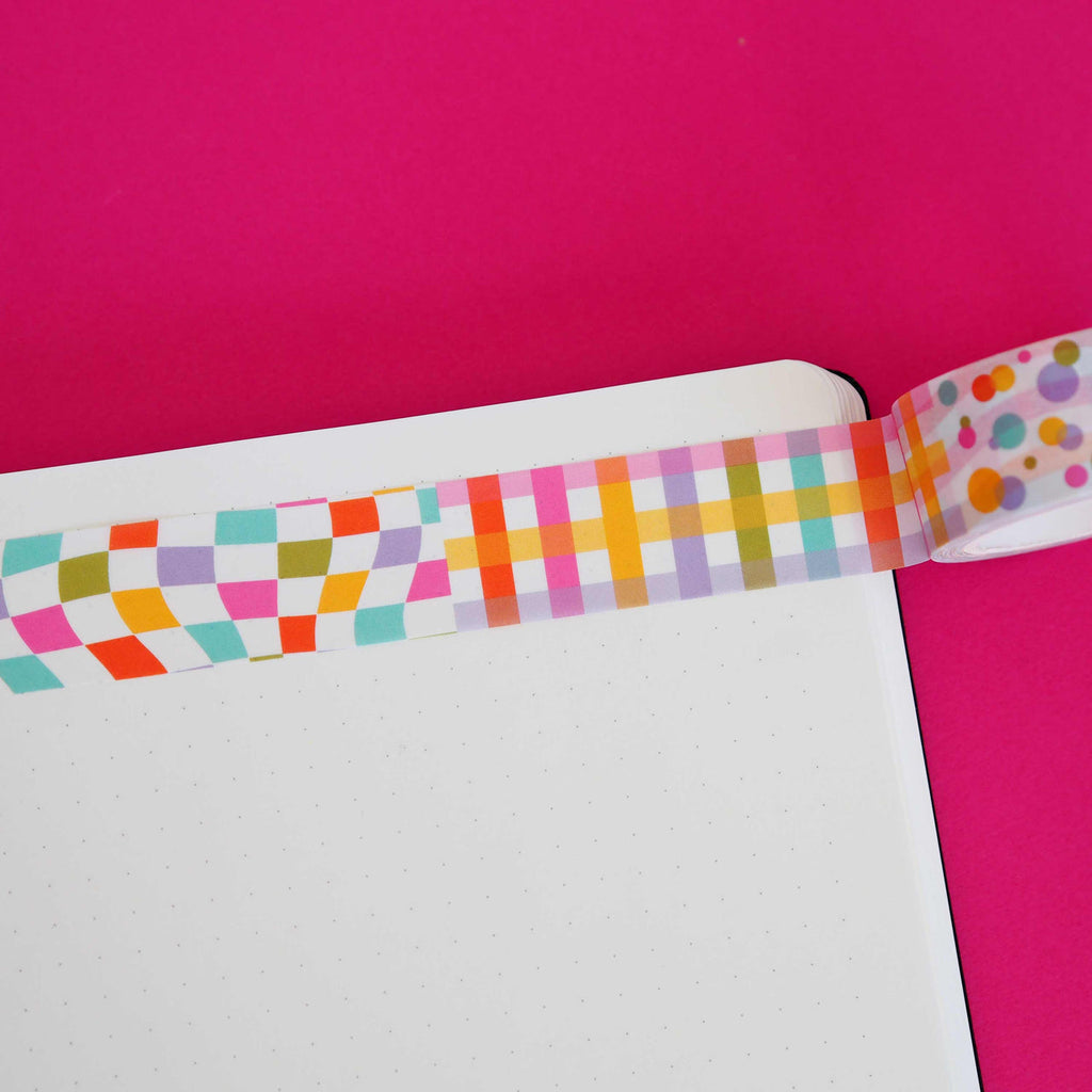 Washi tape with white background and different bright patterns including wavy checkerboard, gingham plaid and dots in red,bright pink, olive, yellow, lilac and aqua. 