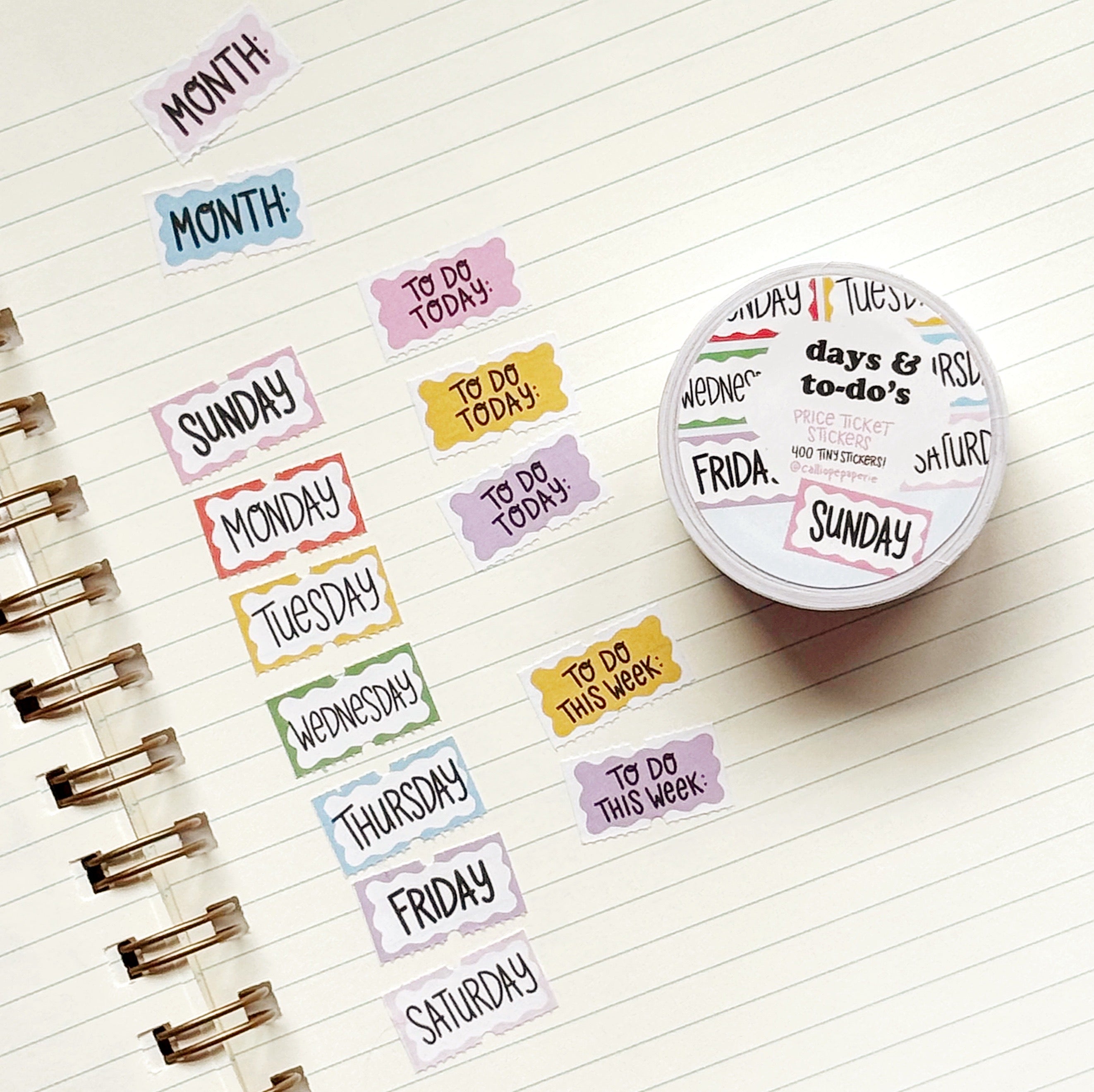 Small stickers with yellow, pink, white, blue backgrounds and black text says, "Sunday, Monday, Tuesday, Wednesday, Thursday, Friday, Saturday, To Do today, To do this week, Month".