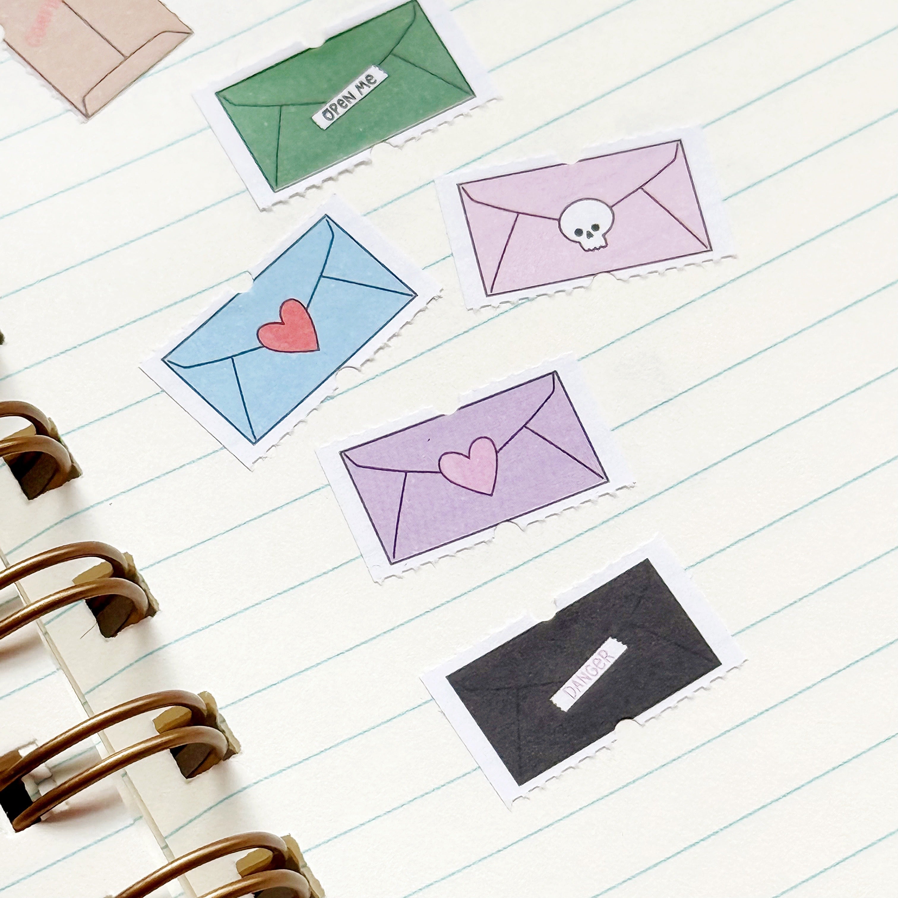 Image of tiny decorative stickers with images of envelopes in bright and pastel colors.