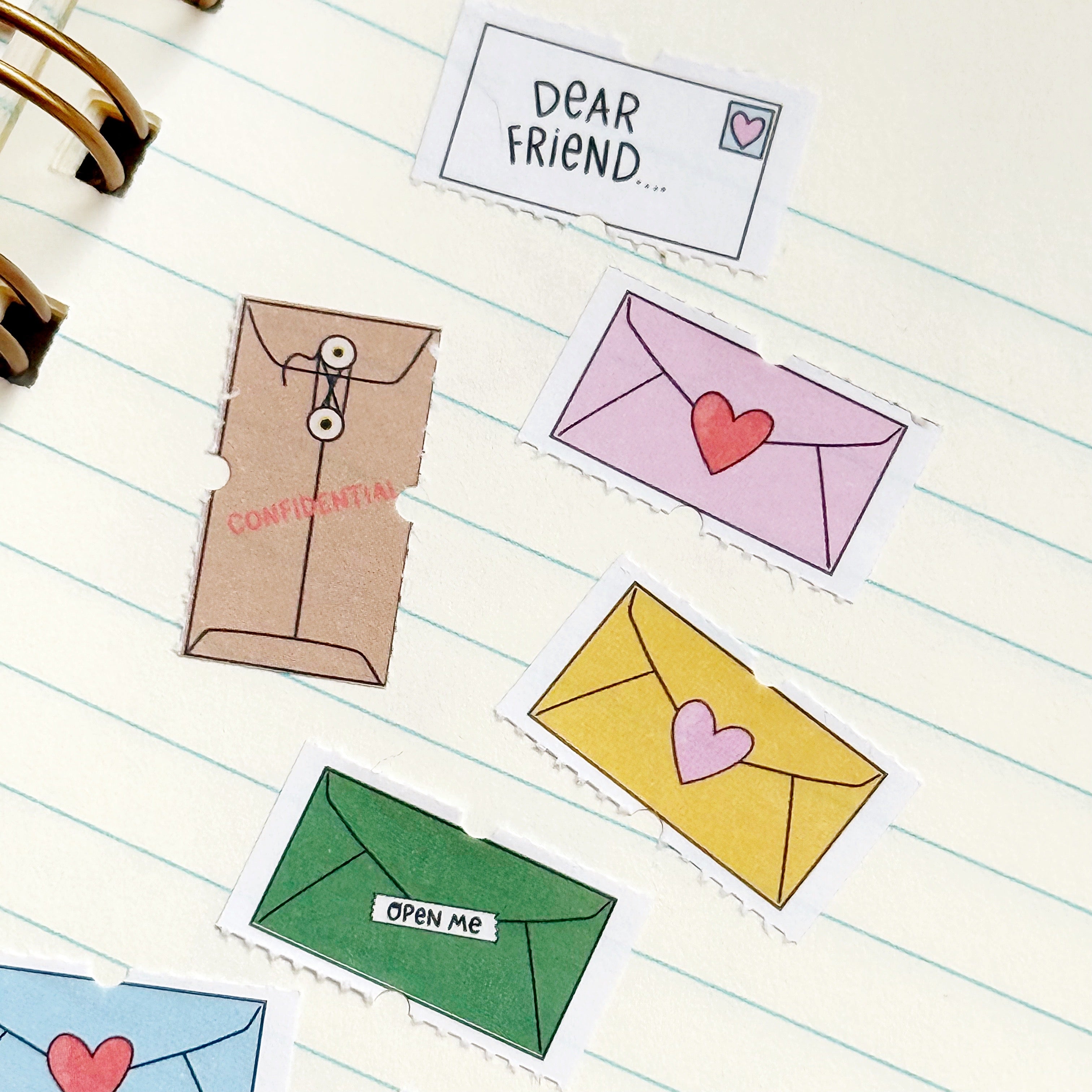 Image of tiny decorative stickers with images of envelopes in bright and pastel colors.