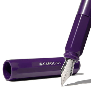 Close up of silver pen nib and purple cap of pen