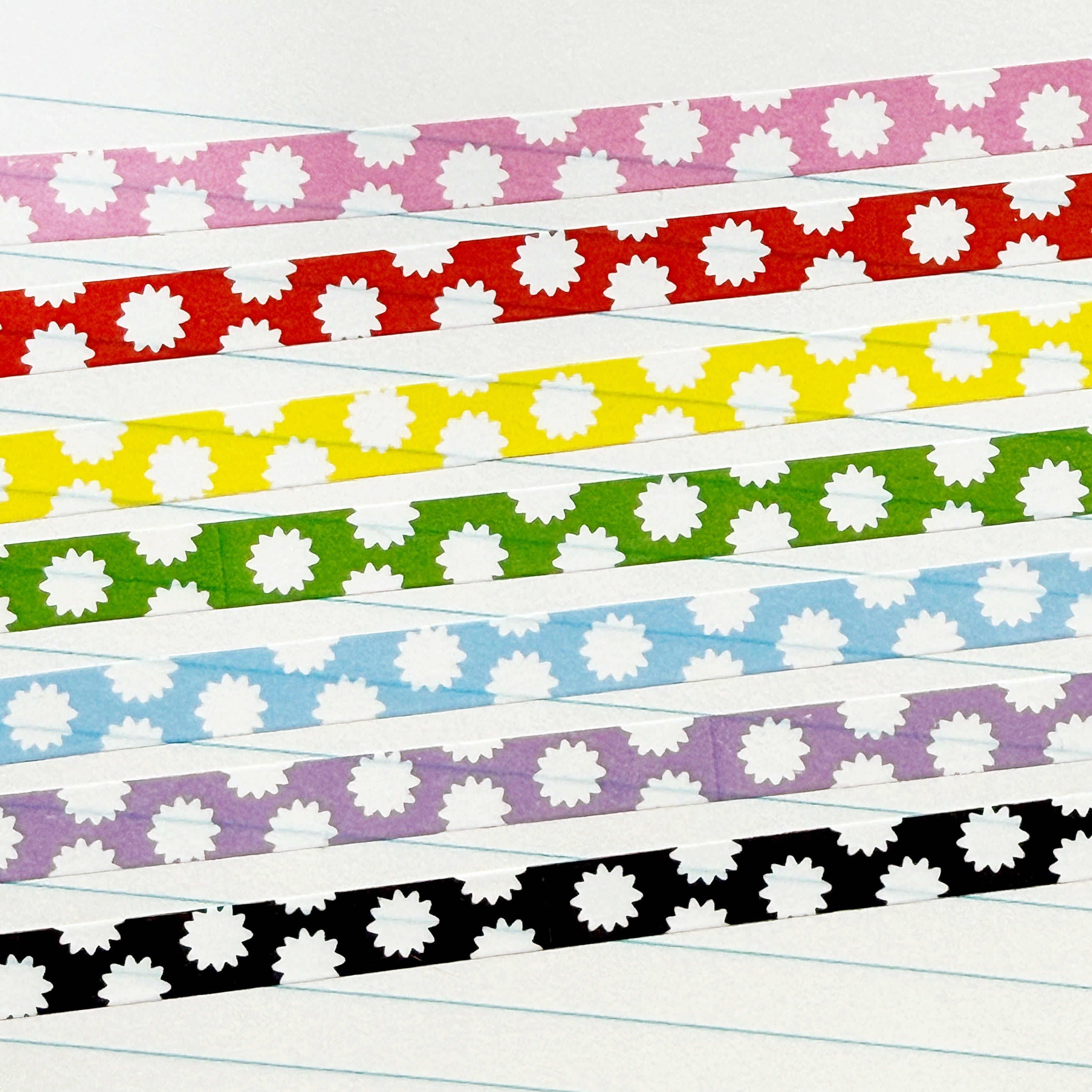 Decorative tape with micro starbursts in pink and white, red and white, yellow and white, green and white, blue and white, black and white and lilac and white.
