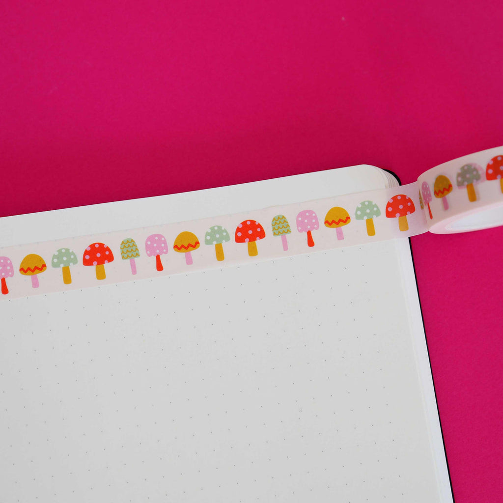 Washi tape with light pink background and images of toadstools in red, pink, yellow, green and lilac.