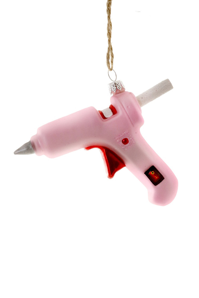 Image of a pink glue gun with red accents. 