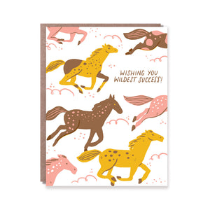 Greeting card with white background and images of horses running in mustard, brown and pink with brown text says, "Wishing you wildest success!". Brown envelope included. 