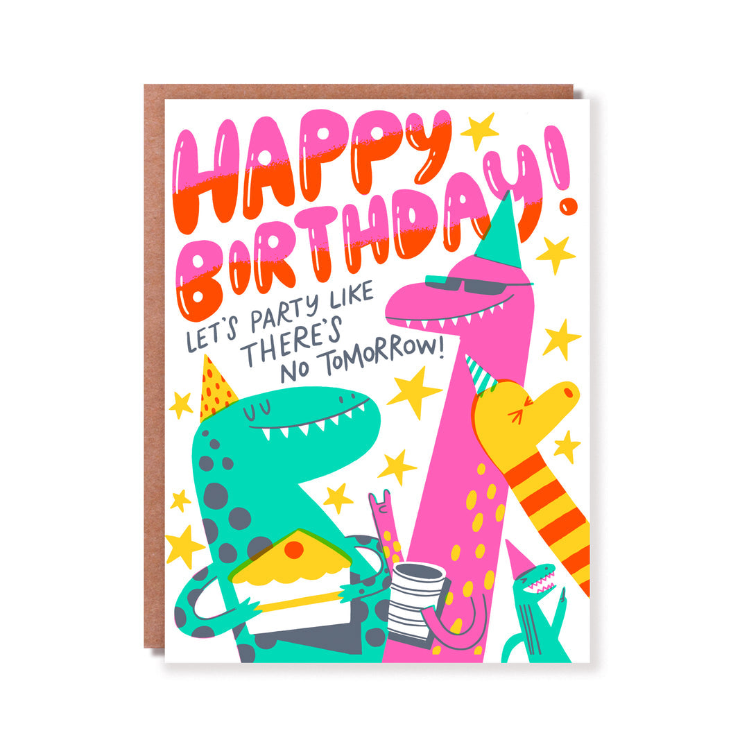 Greeting card with white background and images of pink, green and yellow dinosaurs wearing party hats and having cake. Orange and pink text says, "Happy birthday!" and black text says, "Let's party like there's no tomorrow!". Kraft envelope included. 