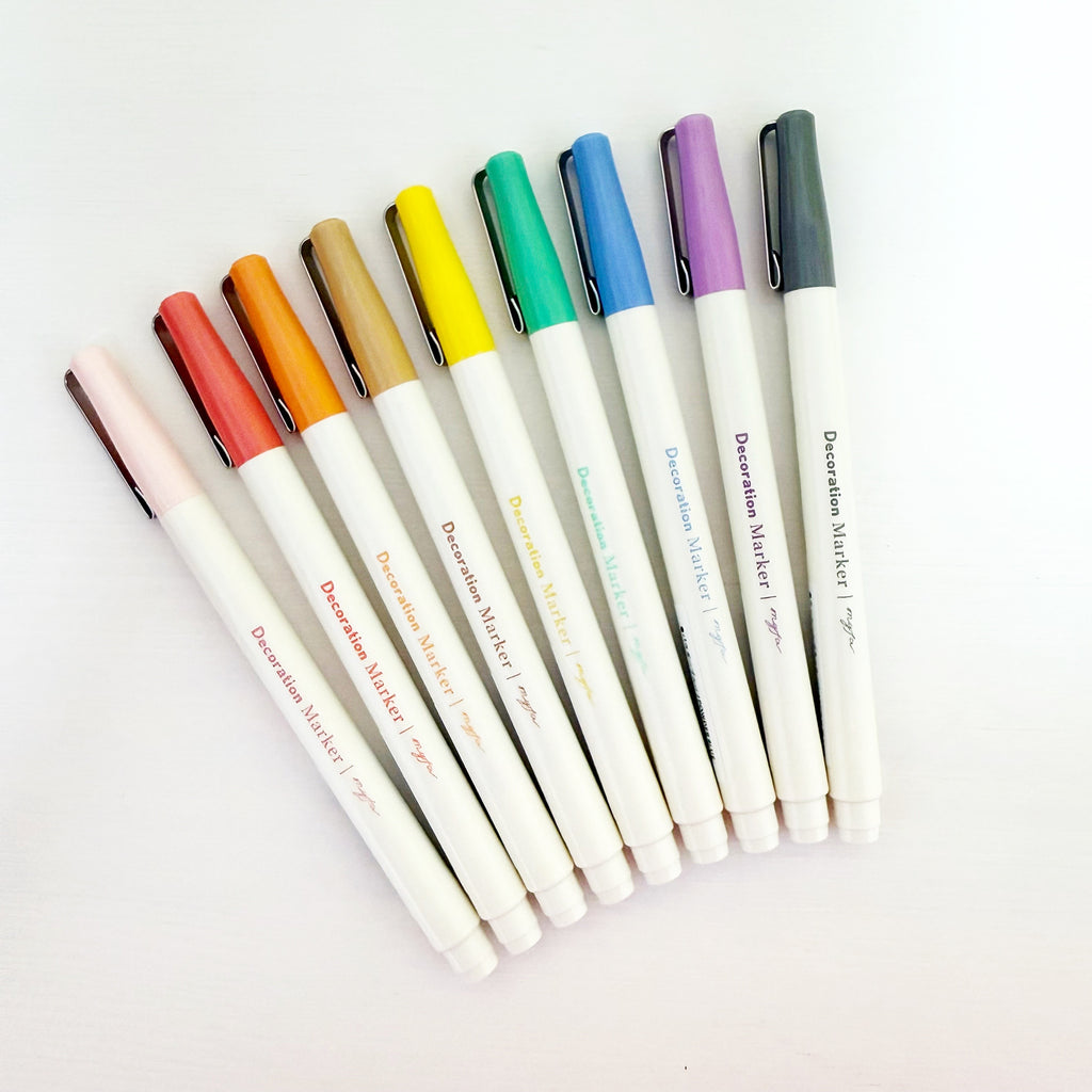 Pens with white barrels and rainbow caps for ink colors.