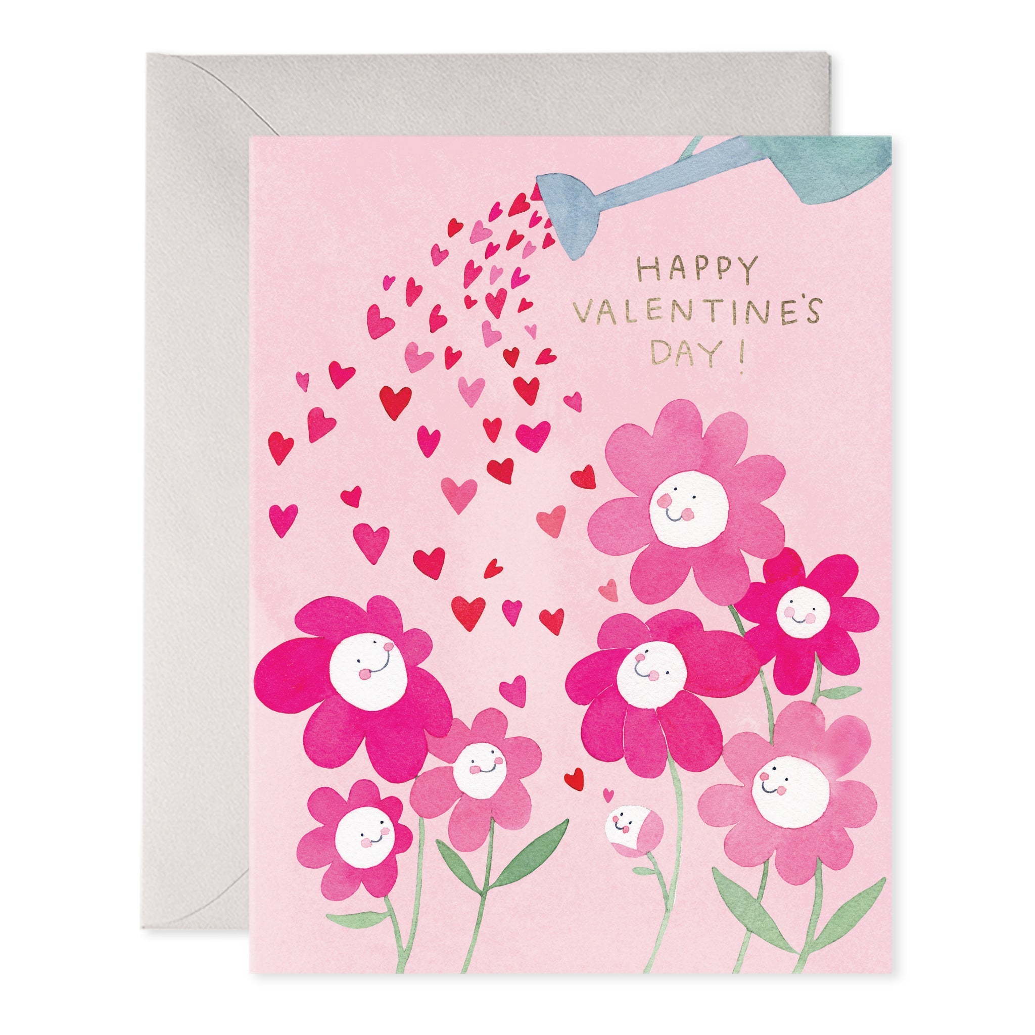 Greeting card with pink background and images of pink and white flowers being watered  with red and pink hearts from a blue watering can. Gold foil text says, "Happy Valentine's Day!". Grey envelope included. 