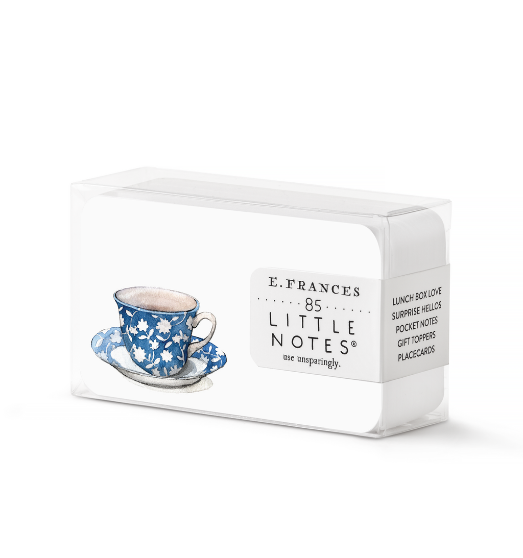 Image of box of tiny notes with white background and image of a blue and white flowered tea cup and saucer. 