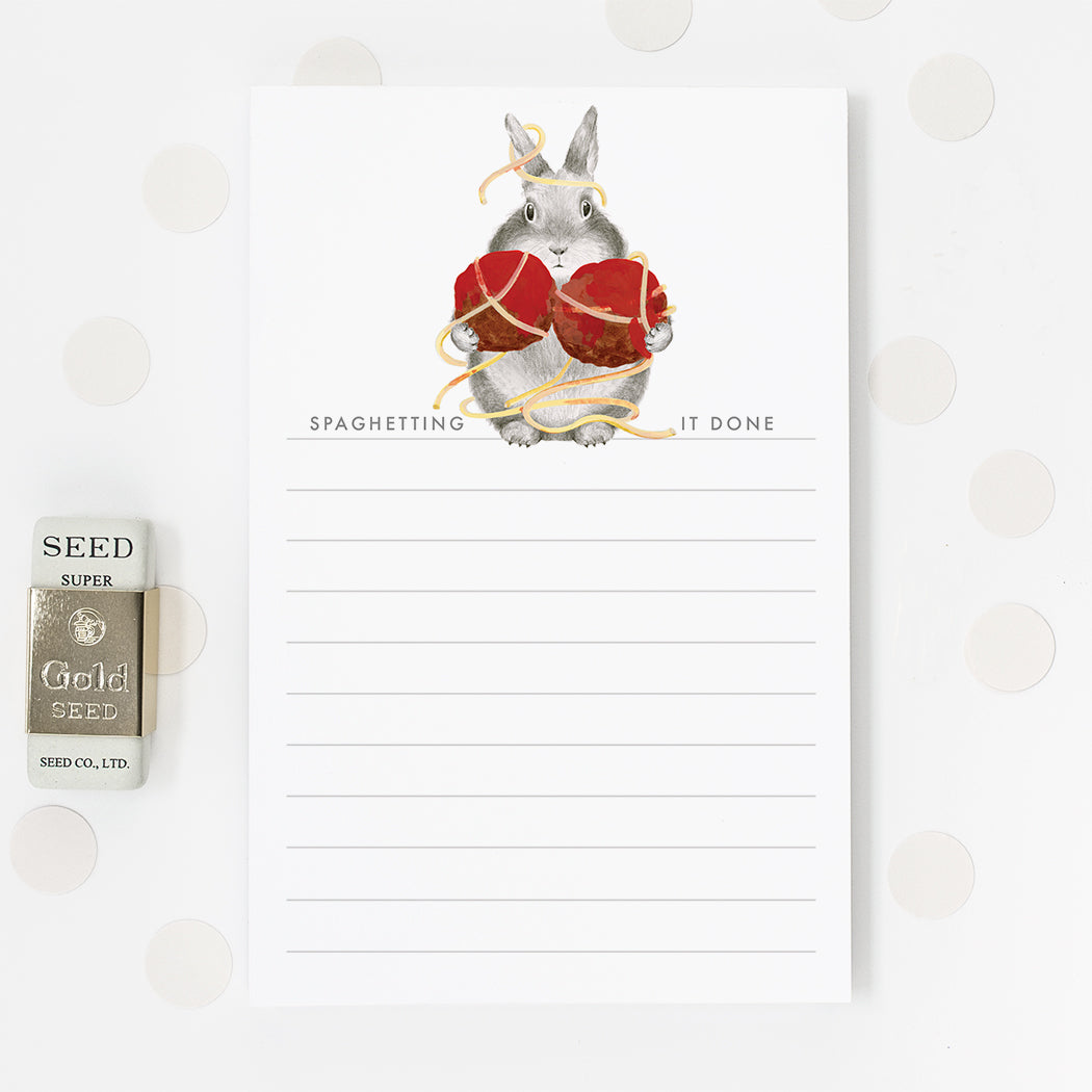 Notepad with white background with image of grey bunny holding two red meatballs with yellow spaghetti with grey lines and text says, "Spaghetting it done". 