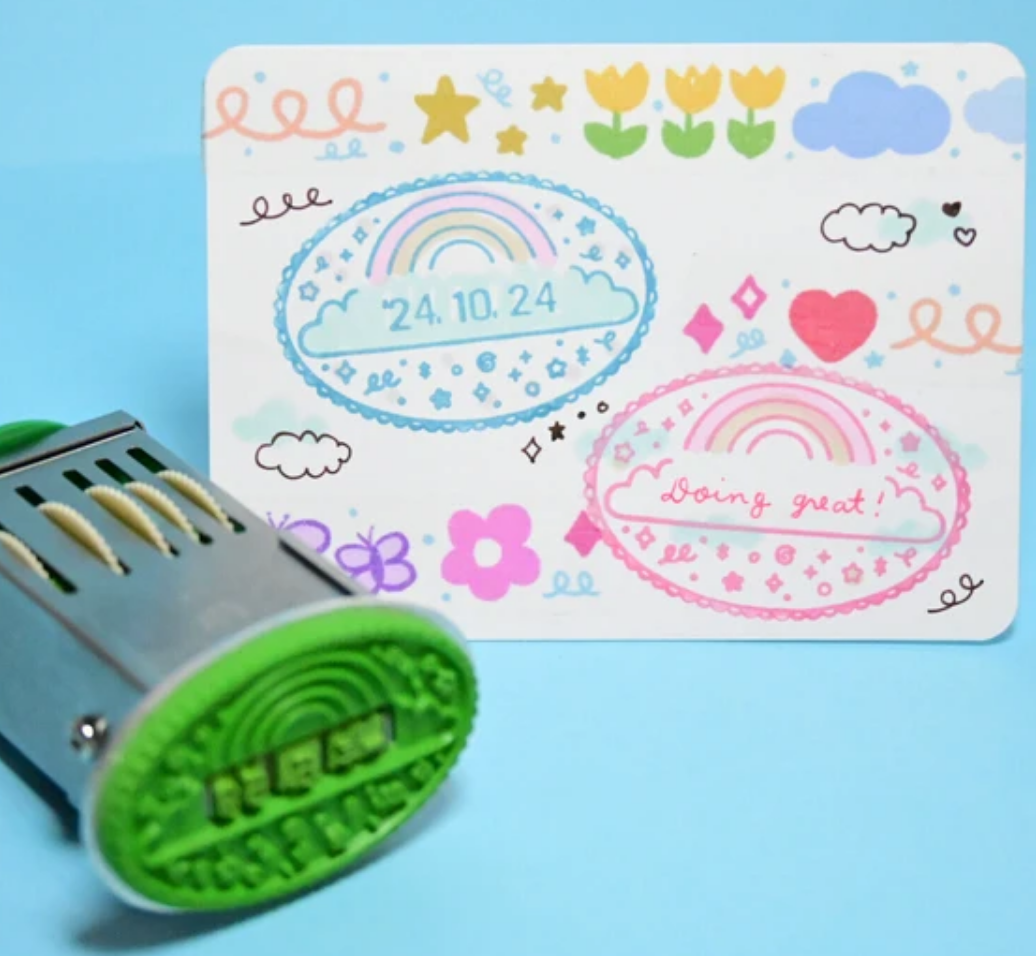 Hand stamper with images of stamps with dates and messages.