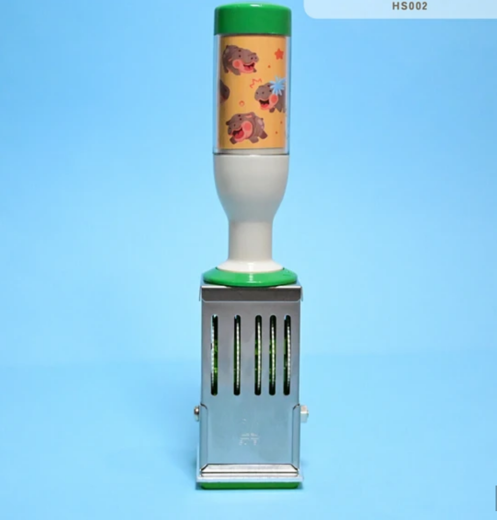 Image of stamper with yellow and green handle.