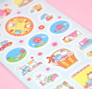 Sticker sheet with blue background and images of tiny animals in rainbow colors.
