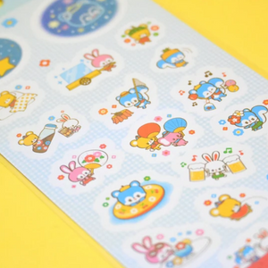 Decorative sticker sheet with blue background and images of animals in pink, blue and yellow. 
