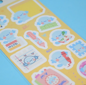 Sticker sheet with yellow background and images of pastel colored mail and stationery items.