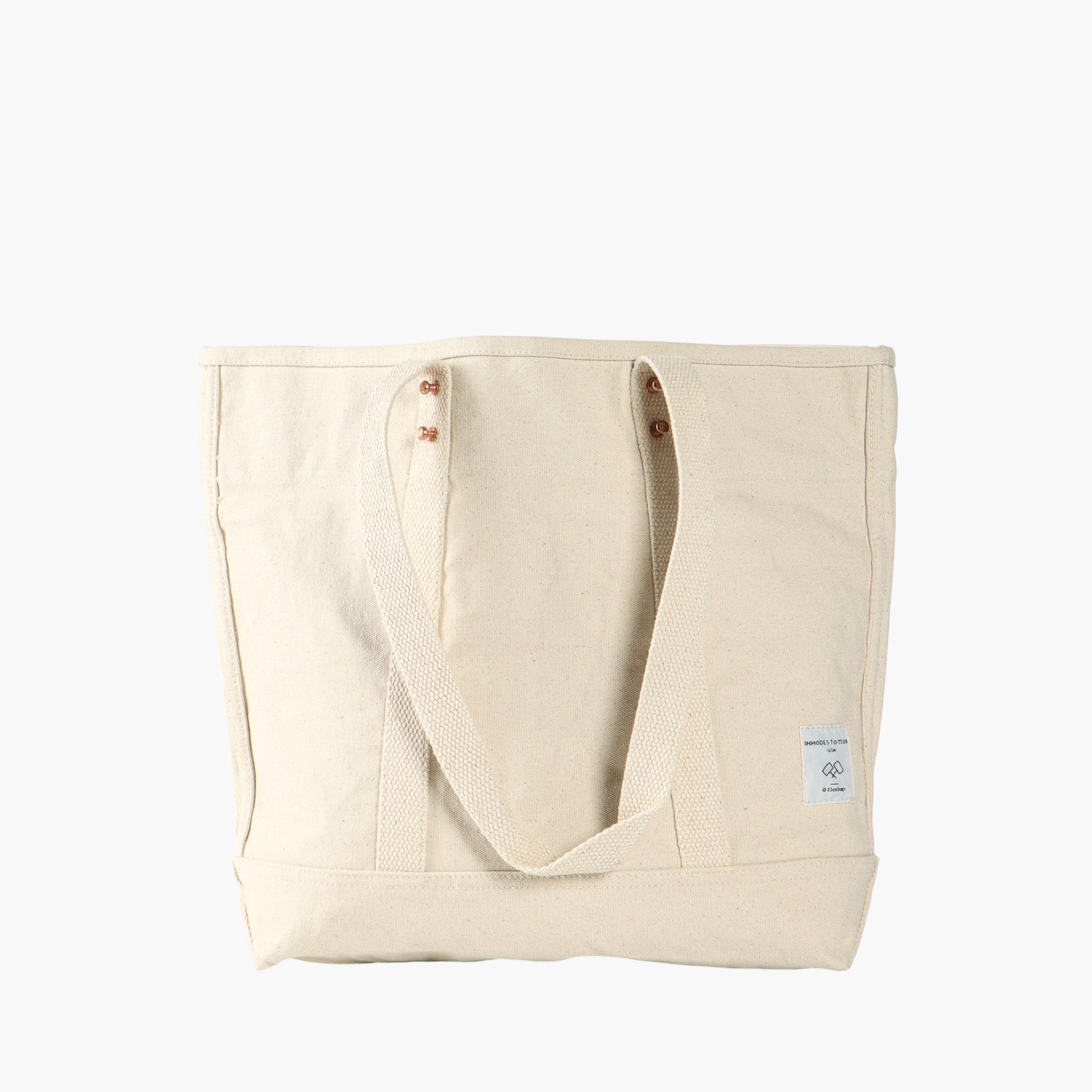 Ivory tote bag with short leather handles and longer ivory webbing handles.