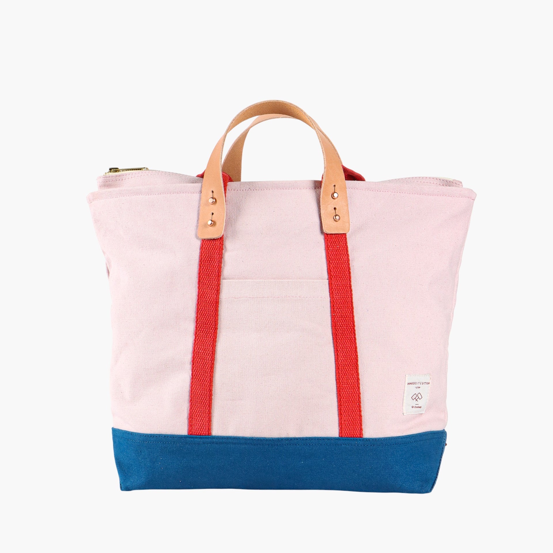 Tote bag in ivory with blue bottom and red webbing. Short leather handles.