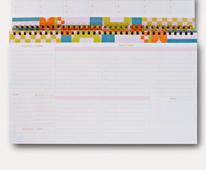 Planner page with white background and pink lines with pink text says, "projects/goals, task focus, tracker, successes and wins, notes".