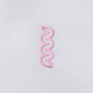 Plastic pink bookmark with squiggles.