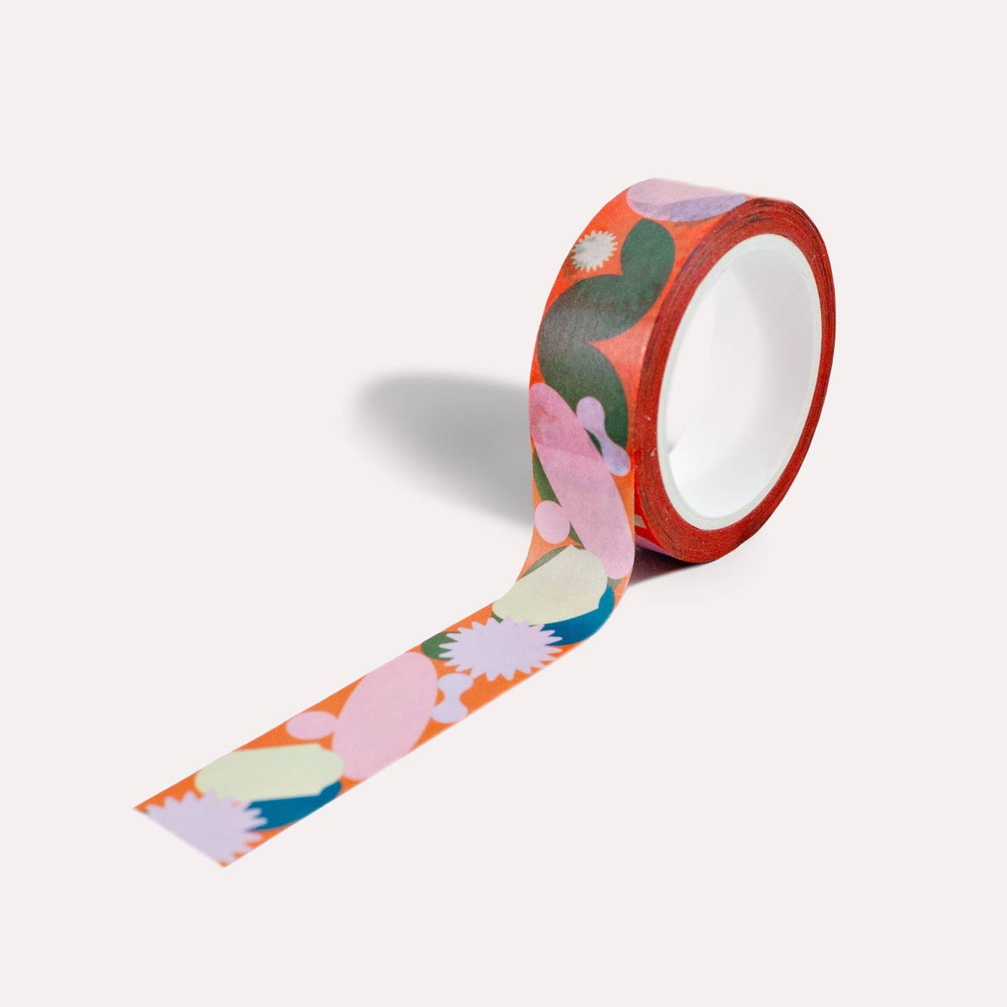 Washi tape with orange background and images in pink, teal, olive and cream. 