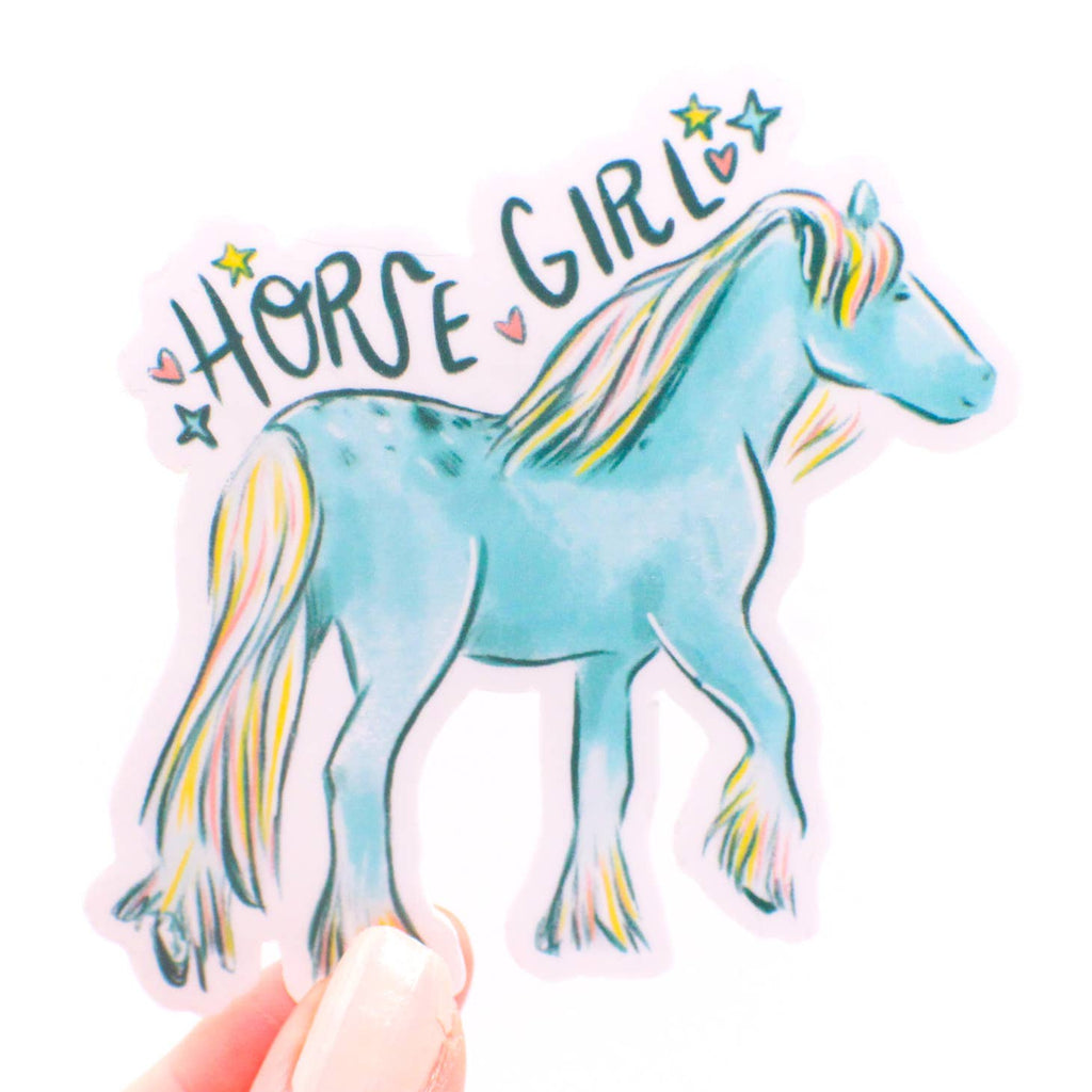 Image of sticker with pink background and a blue horse with blue, pink and yellow mane and black text says, "Horse girl". 