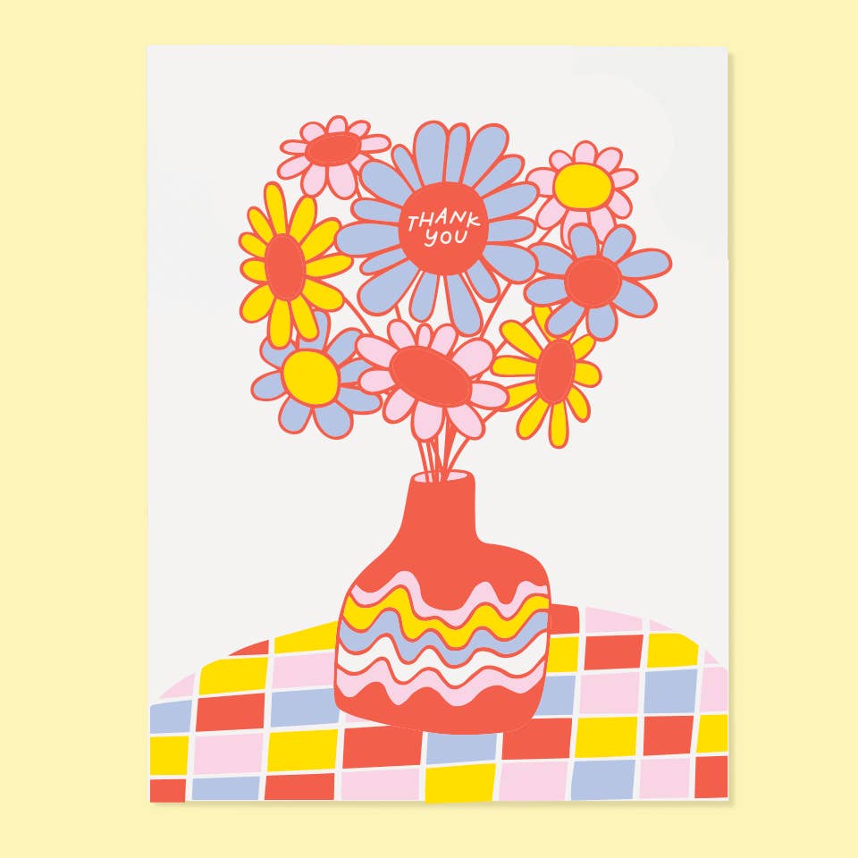 Greeting card with white background and image of a vase of flowers on a checkered table cloth in blue, red, yellow and pink. Red center with white text says, "Thank you". Envelope included.