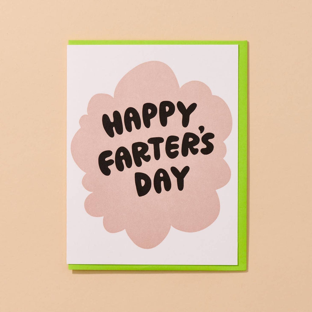 Greeting card image with white background with pink cloud and black text says, "Happy Farter's Day". Neon green envelope included.