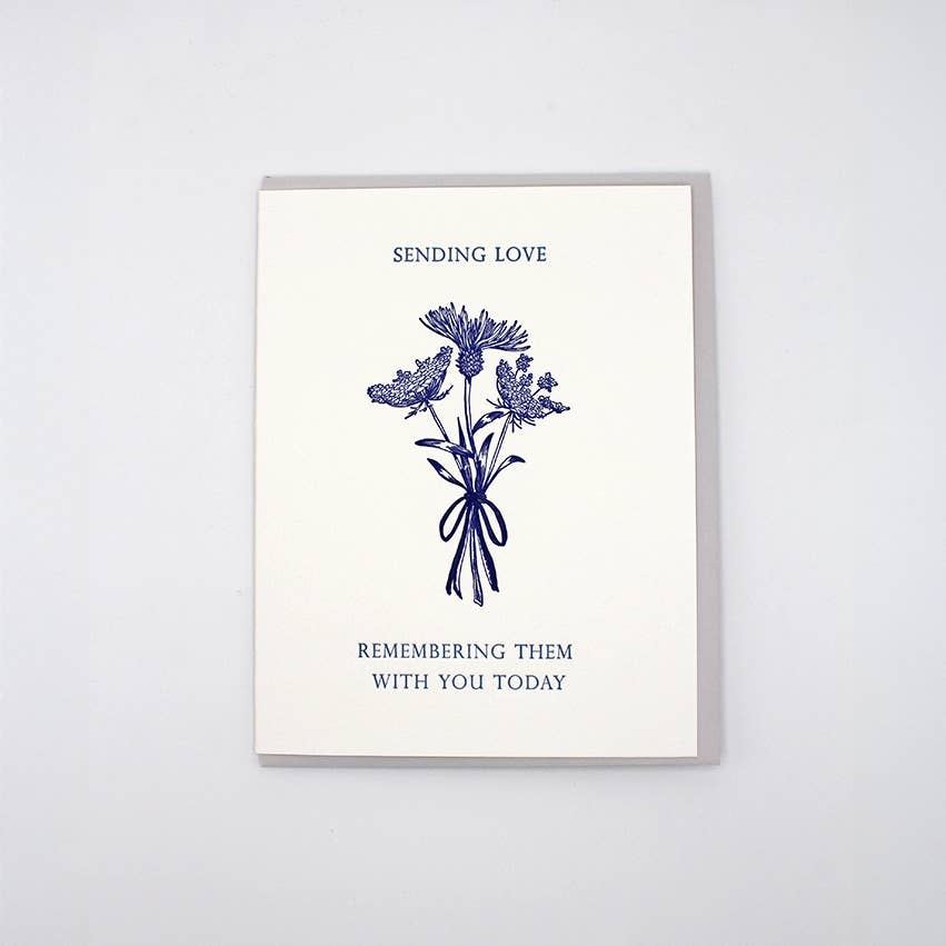 Greeting card with white background and mage of three flower stems and blue text says, "Sending love, Remembering them with you today". Envelope included. 