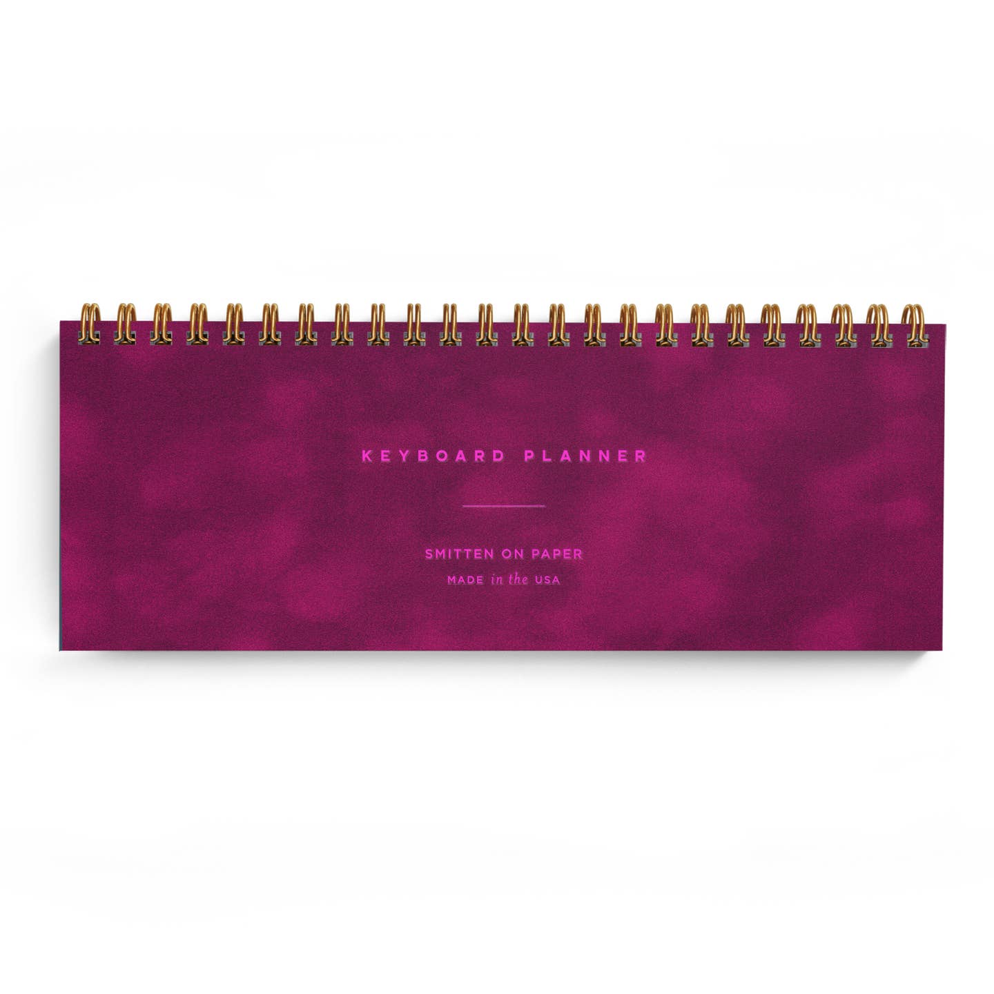 Planner with fuschia background and hot pink text says, "Keyboard Planner, Smitten on Paper, Made in the USA". Gold coil binding at top. 