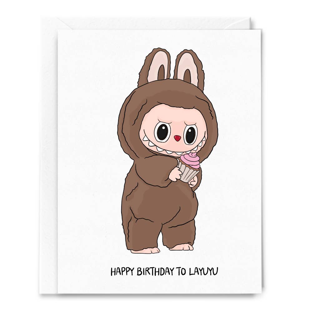 Greeting card with white background and image of a Labubu holding a cupcake and black text says, "Happy Birthday. to Layuye". Envelope included.