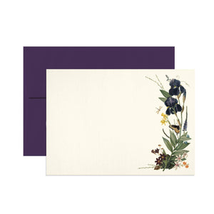 Notecard set with white background and images of black iris on right hand side of card with green leaves. Dark purple envelope included.