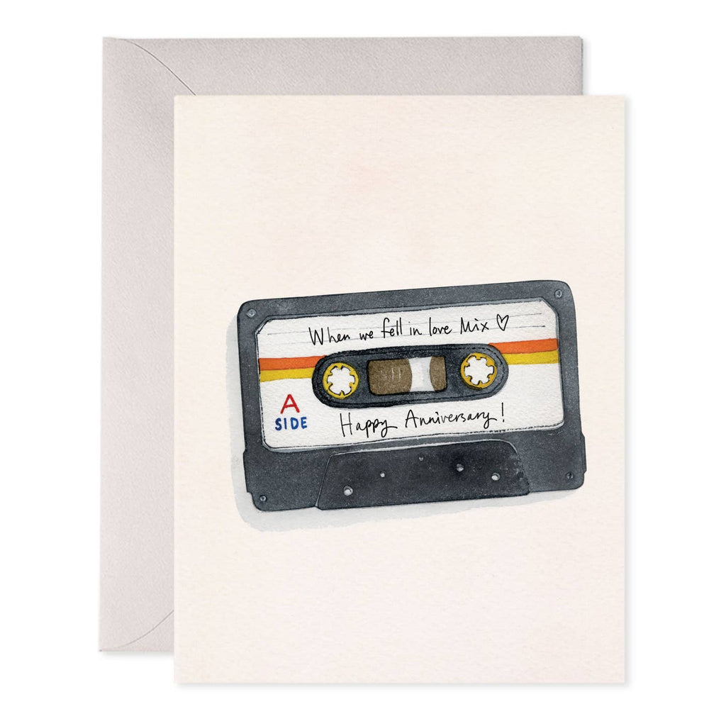 Greeting card with white background and image of a cassette tape with black text says, "When we fell in love mix, Happy Anniversary!". Grey envelope included.