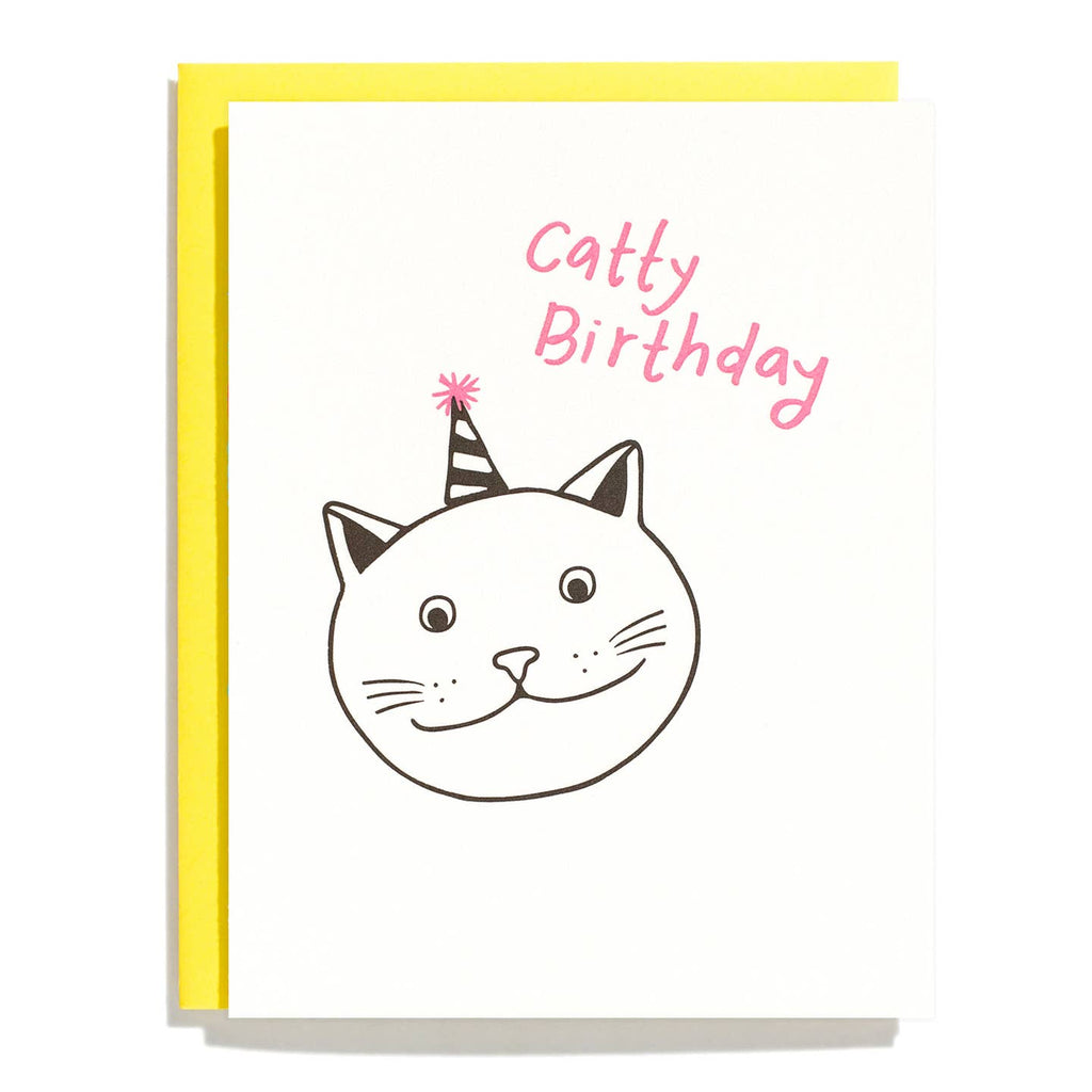 Greeting card with white background and image of a cat face wearing a party hat with pink text says, "Catty Birthday". Yellow envelope included. 