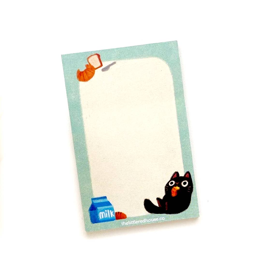 Image of sticky notes with white center and light blue border with image of a black cat in lower right corner , milk and bread in left lower corner and croissant and bread in upper left corner.