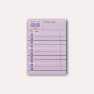 Sticky note with lilac background and blue lines. Red text says, "MTWTFSS, Goal/Objective, Date, Checklist". 