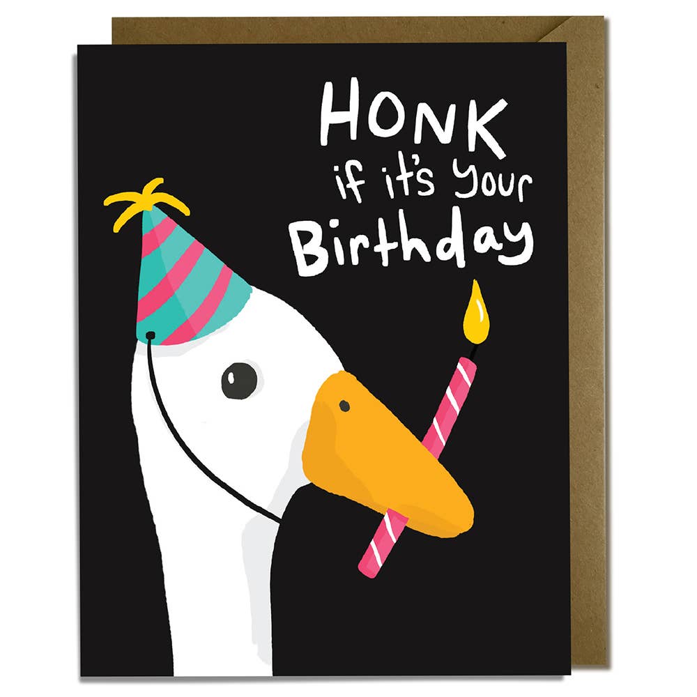 Greeting card with black background and image of white goose wearing a party hat and holding a pink birthday candle in its beak. White text says, "Honk if it's your birthday". Kraft envelope included. 