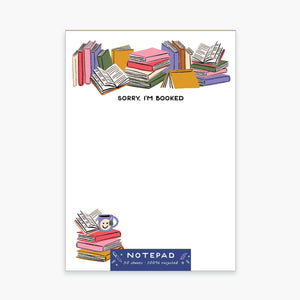 Notepad with white background with image of stacks of books along top of pad in pink, red, lilac, green and cream. Black text says, "Sorry, I'm booked". Stack of books with mug of tea with smiley face in bottom left corner. 