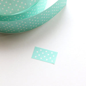 Label sticker with aqua background with white dots