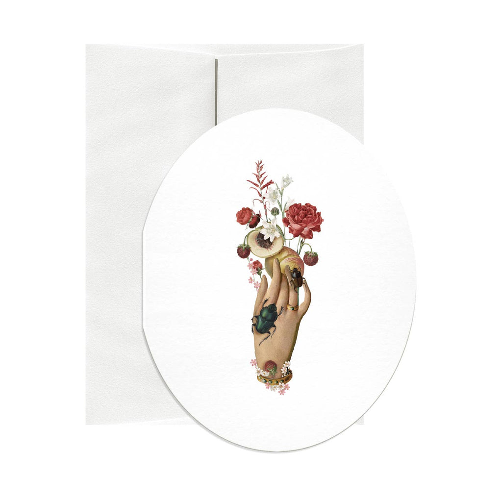 Oval greeting card with white background and image of a hand holding a peach and flowers with a black beetle on the hand. Envelope included.