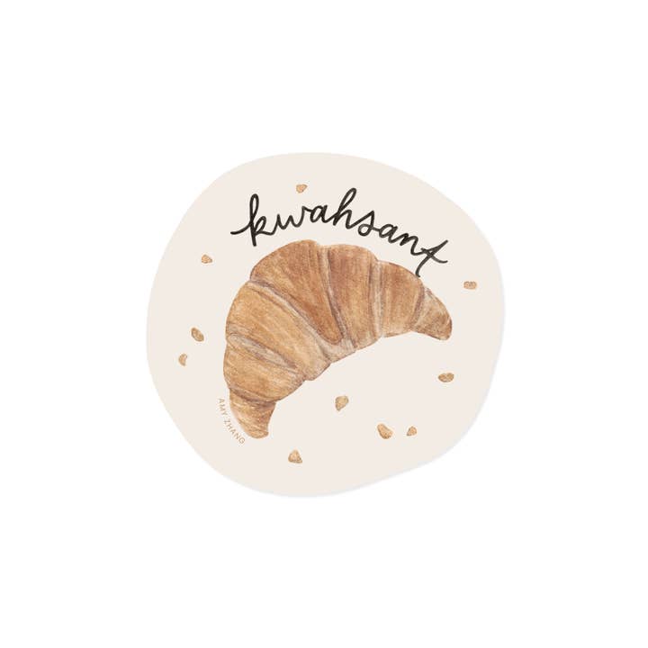 Decorative sticker with cream background and image of golden brown croissant with black text says, "kwahsant". 